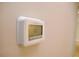 A close-up of a thermostat on the wall at 537 Eastside Dr, Dacula, GA 30019
