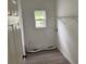 Clean laundry room with window and shelving, ready for appliances at 5709 Newnan Cir, Austell, GA 30106