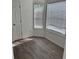 Bright sitting area featuring two windows with blinds and wood-style flooring at 5709 Newnan Cir, Austell, GA 30106