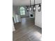 Open concept living room with fireplace, large window and modern lighting at 5709 Newnan Cir, Austell, GA 30106
