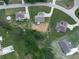 An aerial shot showcasing a home surrounded by green lawns, mature trees, and other residences in the neighborhood at 114 Saddle Wood Dr, Dallas, GA 30157