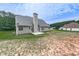 View of the back exterior of a home, featuring siding, chimney, windows, and a concrete patio at 114 Saddle Wood Dr, Dallas, GA 30157