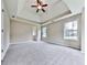Spacious bedroom featuring trey ceilings, a ceiling fan, neutral carpeting, and natural light at 114 Saddle Wood Dr, Dallas, GA 30157