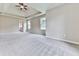 Spacious main bedroom featuring a trey ceiling, ceiling fan, neutral carpeting, and natural light at 114 Saddle Wood Dr, Dallas, GA 30157