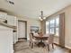 Lovely dining area with a round table, hardwood floors, and a large window with curtains at 114 Saddle Wood Dr, Dallas, GA 30157
