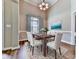 This dining room features modern lighting, seating for six, and a large picture window at 114 Saddle Wood Dr, Dallas, GA 30157