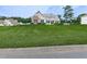 Exterior view of a house on a hill with a well-maintained front lawn at 114 Saddle Wood Dr, Dallas, GA 30157