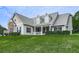 View of home's exterior featuring a manicured lawn, covered porch, and manicured shrubs at 114 Saddle Wood Dr, Dallas, GA 30157