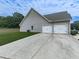Spacious two-car garage with a long driveway and well-maintained exterior siding at 114 Saddle Wood Dr, Dallas, GA 30157