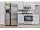 Kitchen featuring stainless steel appliances including fridge, oven, range hood, and microwave at 114 Saddle Wood Dr, Dallas, GA 30157