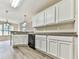 This kitchen features white cabinetry, modern countertops, and views into the breakfast nook at 114 Saddle Wood Dr, Dallas, GA 30157