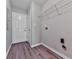 Spacious laundry room featuring wood-look flooring, neutral paint, and a wire shelf at 114 Saddle Wood Dr, Dallas, GA 30157