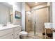 Bathroom featuring a large glass-enclosed shower with tan tiling, vanity, and neutral walls at 3133 Quinn Pl, Atlanta, GA 30341