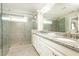 Elegant bathroom featuring a glass-enclosed shower, granite countertop and double sinks with modern fixtures at 3133 Quinn Pl, Atlanta, GA 30341