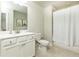 Bathroom featuring a shower-tub combo with white shower curtain, vanity, and neutral walls at 3133 Quinn Pl, Atlanta, GA 30341