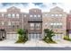View of brick townhome with attached garages, manicured landscaping and inviting curb appeal at 3133 Quinn Pl, Atlanta, GA 30341
