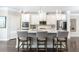 Bright kitchen features white cabinetry, stainless steel appliances, and a spacious island with barstool seating at 3133 Quinn Pl, Atlanta, GA 30341