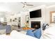 Cozy living room with fireplace, tv, ceiling fan, and view of the eat-in kitchen at 3133 Quinn Pl, Atlanta, GA 30341