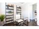 Stylish home office with modern glass desk, shelving, and easy access to a powder room at 3133 Quinn Pl, Atlanta, GA 30341
