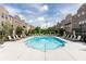 Community pool with lounge chairs surrounded by brick townhouses under a sunny sky at 3133 Quinn Pl, Atlanta, GA 30341