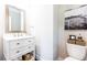 Updated powder room featuring stylish vanity with marble countertop and framed art at 3133 Quinn Pl, Atlanta, GA 30341