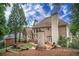 Expansive backyard featuring multiple patios, mature trees, and brick exterior of the home at 8630 Moor Park Run, Duluth, GA 30097