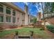 Spacious backyard with brick patios, lush lawn, and mature trees create a private retreat at 8630 Moor Park Run, Duluth, GA 30097