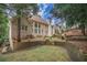 Spacious backyard featuring a well-maintained lawn, retaining walls, and mature trees providing ample shade at 8630 Moor Park Run, Duluth, GA 30097