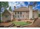 A well-landscaped backyard with multiple patios, mature trees, and retaining walls for privacy at 8630 Moor Park Run, Duluth, GA 30097