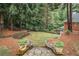 Serene backyard featuring a stone walkway, mature trees, and landscaped beds at 8630 Moor Park Run, Duluth, GA 30097