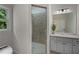 Bathroom with a glass shower enclosure, double vanity, and modern fixtures at 8630 Moor Park Run, Duluth, GA 30097