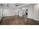 An open bedroom features hardwood flooring and access to other rooms in the home at 8630 Moor Park Run, Duluth, GA 30097