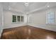 Spacious bedroom with hardwood floors, recessed lighting, a tray ceiling and large windows with shutter blinds at 8630 Moor Park Run, Duluth, GA 30097