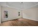 Bedroom featuring a tray ceiling, hardwood floors, and dual windows at 8630 Moor Park Run, Duluth, GA 30097