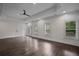 Spacious bedroom features a ceiling fan, natural light, and hardwood floors at 8630 Moor Park Run, Duluth, GA 30097