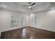 Spacious bedroom features a ceiling fan, door to the backyard, and hardwood floors at 8630 Moor Park Run, Duluth, GA 30097