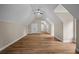 Open bonus room area with hardwood floors, vaulted ceiling, and recessed lighting at 8630 Moor Park Run, Duluth, GA 30097