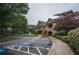 Inviting community entrance with lush landscaping, convenient parking, and attractive architectural details at 8630 Moor Park Run, Duluth, GA 30097