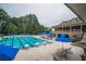 A large community pool with lap lanes, umbrellas, and plenty of lounge chairs for residents at 8630 Moor Park Run, Duluth, GA 30097