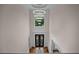 Elegant foyer with soaring ceilings, modern chandelier, and wrought iron front doors at 8630 Moor Park Run, Duluth, GA 30097
