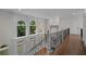 Second floor hallway with large windows providing abundant natural light at 8630 Moor Park Run, Duluth, GA 30097