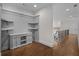 Upstairs hallway with custom built-in cabinet and open staircase with decorative wrought iron railing at 8630 Moor Park Run, Duluth, GA 30097