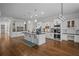 Spacious kitchen with island, modern lighting, stainless appliances, and hardwood flooring at 8630 Moor Park Run, Duluth, GA 30097