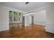 Open-concept living room with hardwood floors, modern lighting, and large windows at 8630 Moor Park Run, Duluth, GA 30097