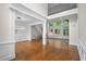 Spacious living room showcasing hardwood floors, wainscoting, and ample natural light at 8630 Moor Park Run, Duluth, GA 30097