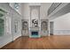 Inviting living room boasting hardwood floors, a fireplace, and custom built-in shelving at 8630 Moor Park Run, Duluth, GA 30097