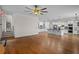 Spacious open-concept living room showcasing beautiful hardwood floors and a kitchen with a center island at 8630 Moor Park Run, Duluth, GA 30097