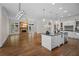 Open-concept living space showcasing kitchen island, fireplace, and hardwood floors at 8630 Moor Park Run, Duluth, GA 30097