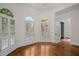 Sunlit living area with hardwood floors, plantation shutters, and elegant archways at 8630 Moor Park Run, Duluth, GA 30097