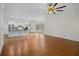 Bright living room with hardwood floors, large windows, and an open view of the modern kitchen at 8630 Moor Park Run, Duluth, GA 30097